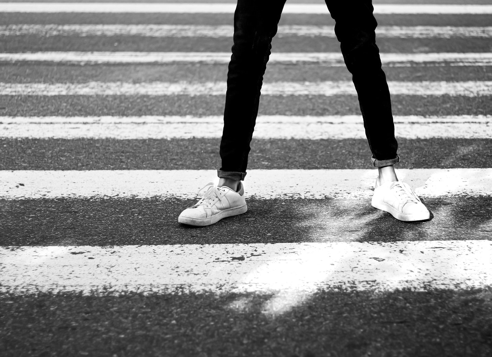 a person standing in the middle of a cross walk